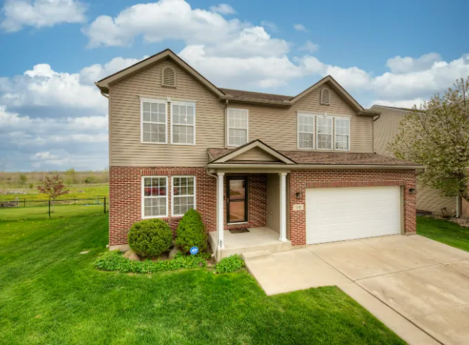 Brick house with tan siding fenton Michigan.