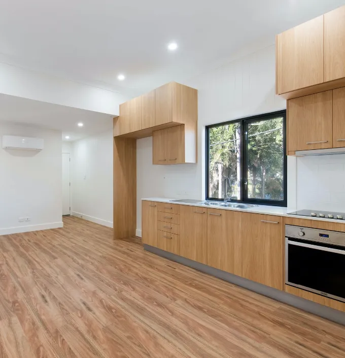 Apartment unit with open floor plan and wooden floors.